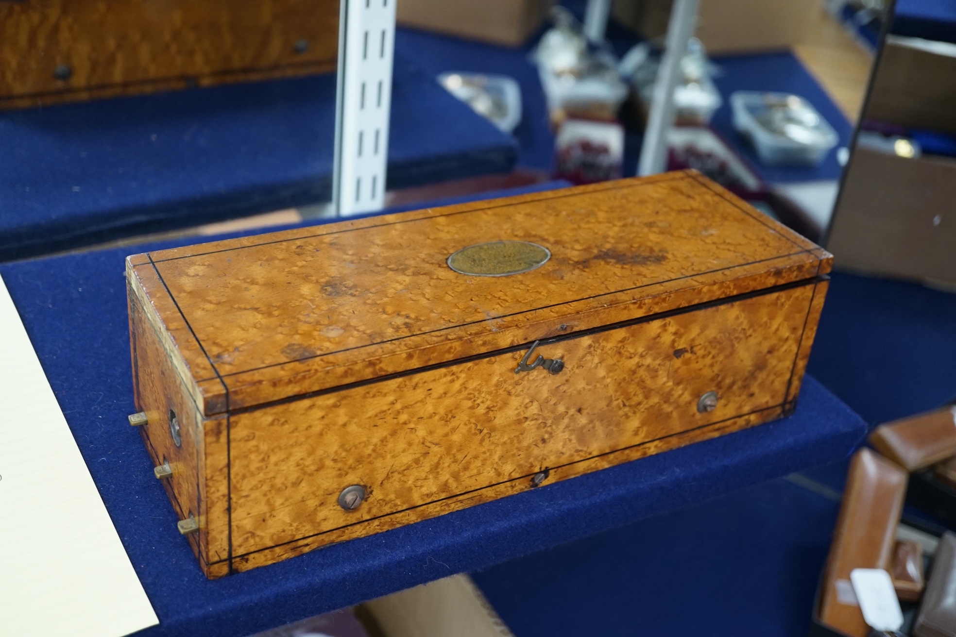 A small mid 19th century Swiss musical box in a bird’s eye maple case, side key wound, 30cm wide. Condition - fair.